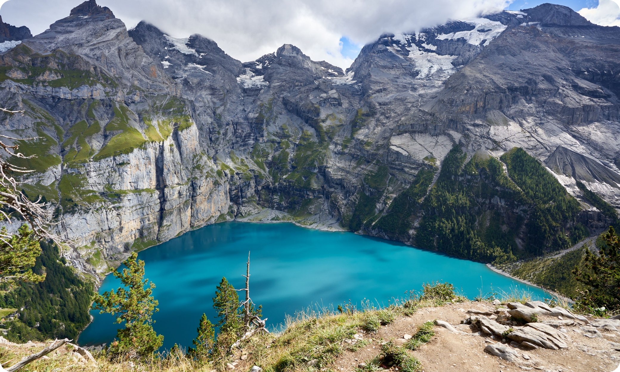 Lake Oeschinen, Switzerland — turquoise lake beneath mountain peaks